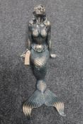 A cast iron figure of a mermaid