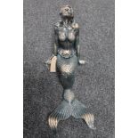 A cast iron figure of a mermaid