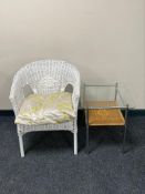 A wicker armchair and a metal and wicker side table