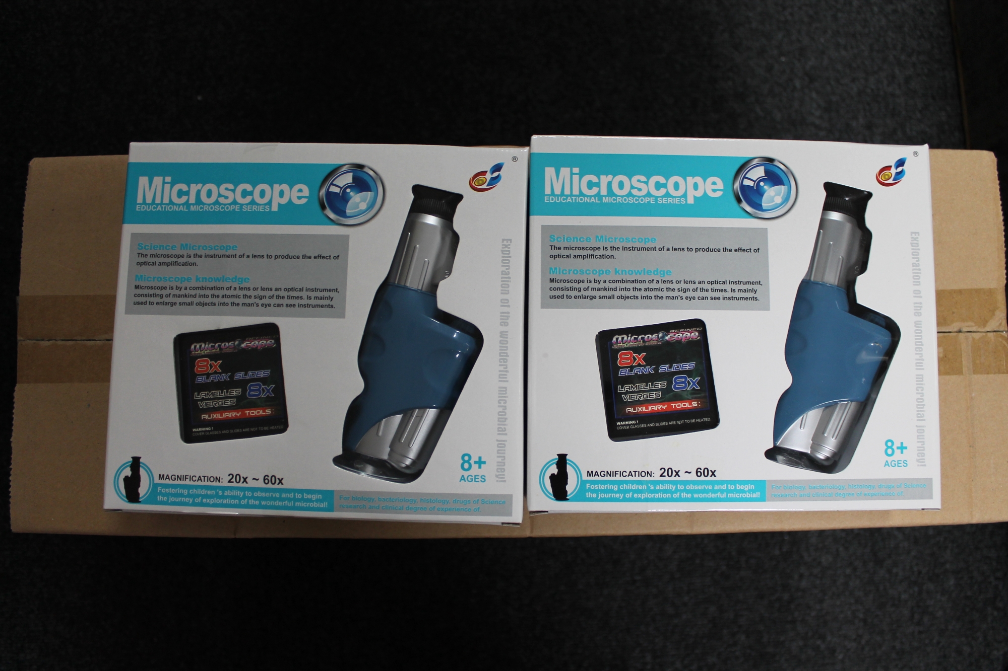 Twenty boxed educational microscopes