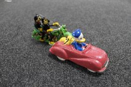 Two cast iron figures - Donald Duck, Pluto in car,