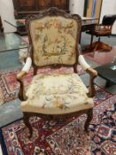 A continental walnut framed armchair in tapestry fabric,