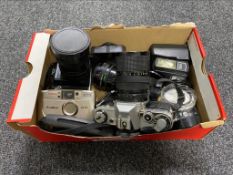 A box of Canon AE-1 camera, Zenit EN camera, Canon AF-10 camera, assorted lens,
