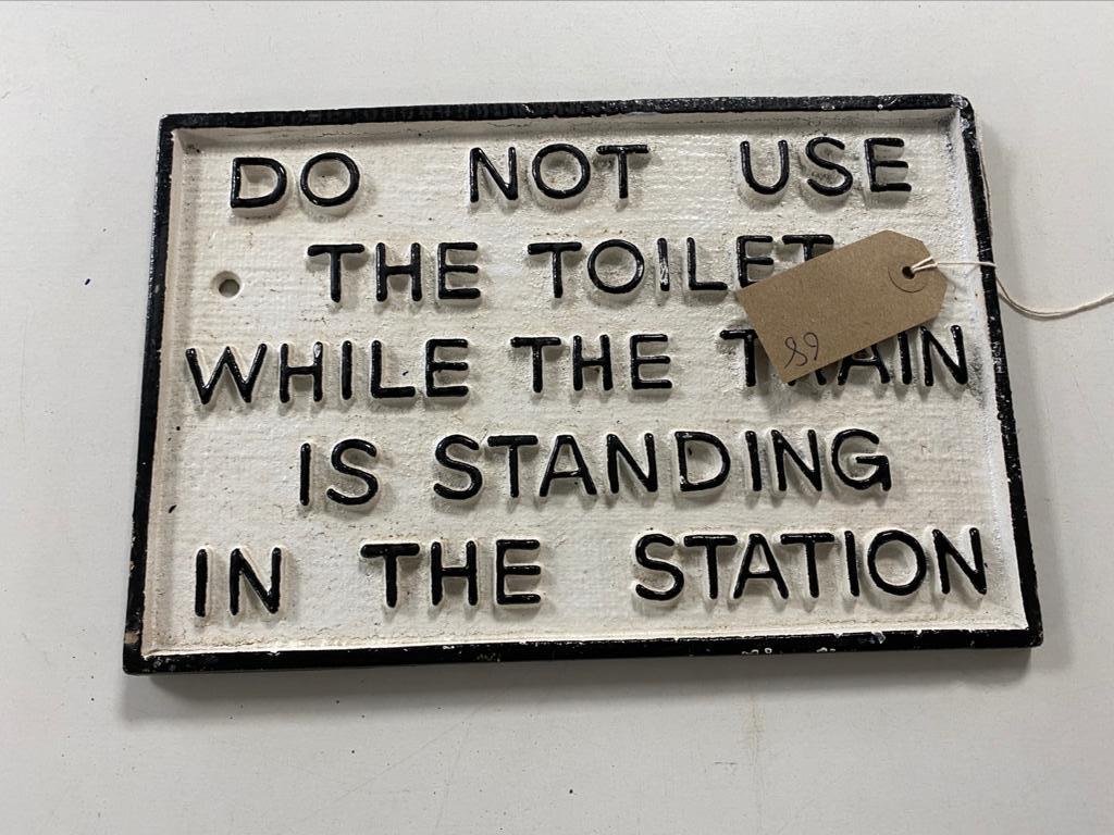 A cast iron train toilet notice