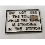 A cast iron train toilet notice