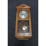 A 20th century eight day wall clock with silvered dial,