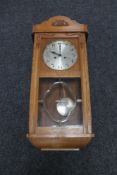 A 20th century eight day wall clock with silvered dial,