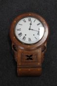 An antique inlaid mahogany wall clock with circular dial