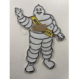 A cast iron plaque - Michelin man