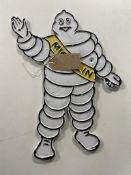 A cast iron plaque - Michelin man