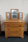 A pine three drawer chest with triple mirror