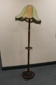An early 20th century oak standard lamp and shade