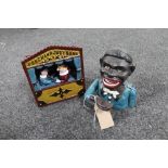 A cast iron Punch and Judy novelty money box together with one other