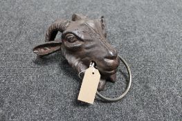 A cast iron goat head horse hitch