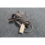 A cast iron goat head horse hitch