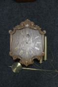 A 20th century continental oak wall clock,