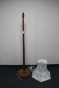 A mid 20th century teak standard lamp and shade