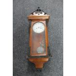 A 20th mahogany cased wall clock with pendulum and key