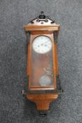 A 20th mahogany cased wall clock with pendulum and key
