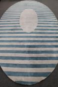 A Kinnasand oval woolen carpet on striped ground,
