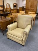 An early 20th century cream vinyl armchair