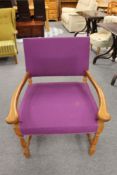 A mid 20th century oak framed armchair in purple fabric