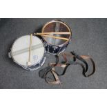 Two snare drums with drum sticks and three leather carrying straps