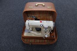 A cased 20th century Prinzess electric sewing machine (continental plug)