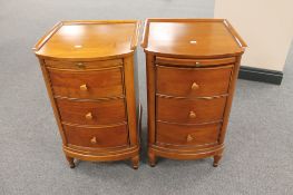 A pair of contemporary pine three drawer bow-fronted bedside chests with slide