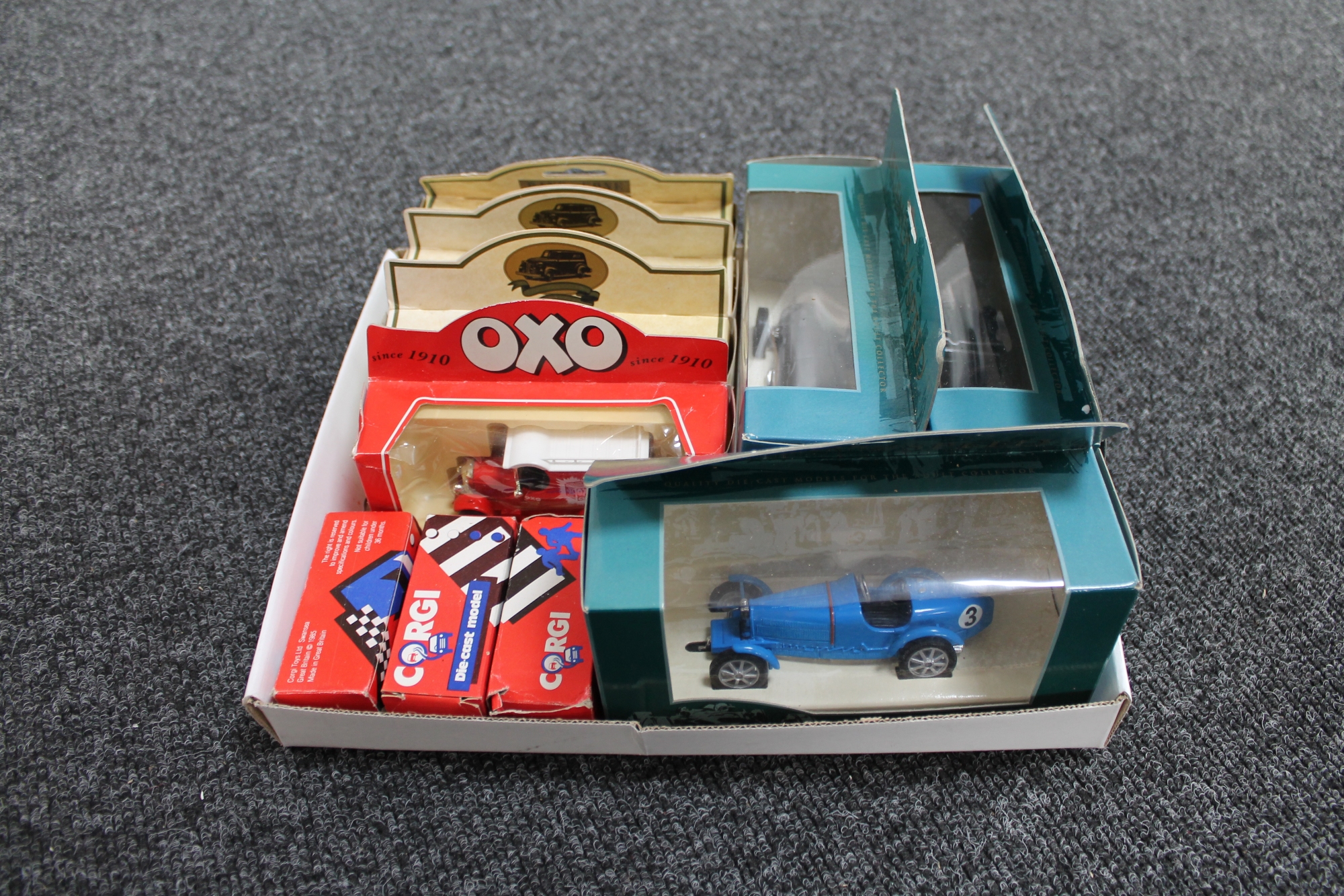A box of ten assorted die cast vehicles including Corgi Legends of Speed,