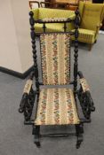 An ebonised rocking chair