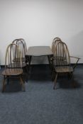 A circular Ercol drop leaf table and five chairs