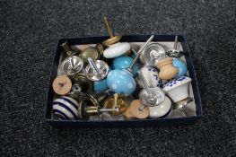A box of porcelain and wooden drawer knobs