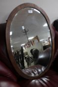 An Edwardian oval beveled edged mirror