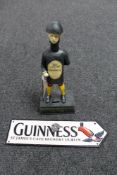 A cast iron Guinness Good for Him and Good for You Jockey money box together with a cast iron