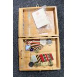 A wooden cigar box containing Russian WWII medals on ribbons and enamelled badges