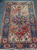 A fringed Persian rug of geometric design
