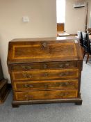 A 19th century continental inlaid oak writing bureau with brass handles and mounts