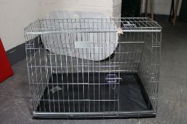 A folding metal dog cage,