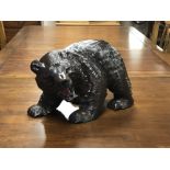 A large Japanese carved bear figure with glass eyes, height 24 cm.