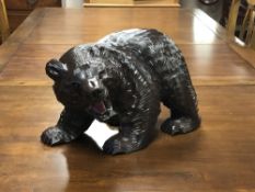 A large Japanese carved bear figure with glass eyes, height 24 cm.