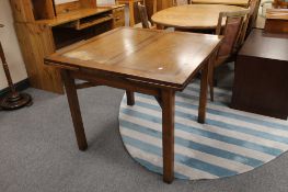 A mid 20th century oak extending dining table