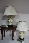 Two pottery table lamps on wooden bases and an Eastern hardwood occasional table