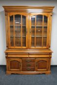 A double door display cabinet fitted cupboards and drawers