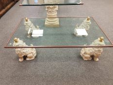 A contemporary glass coffee table foo dog supports with 154 cm x 93 cm