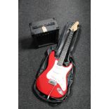 An Encore electric guitar with carry strap together with a KLA 10 lead amplifier with carry strap