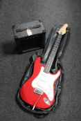 An Encore electric guitar with carry strap together with a KLA 10 lead amplifier with carry strap