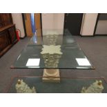 A contemporary glass topped twin pedestal dining table on Corinthian style columns,