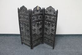 A small carved hardwood three fold fretwork screen