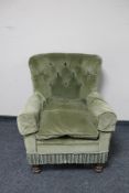 An early 20th century armchair in green button dralon